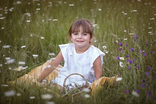 Portraits of a beautiful 4-year-old Argentine girl in a flower field- Buenos Aires - Argentina