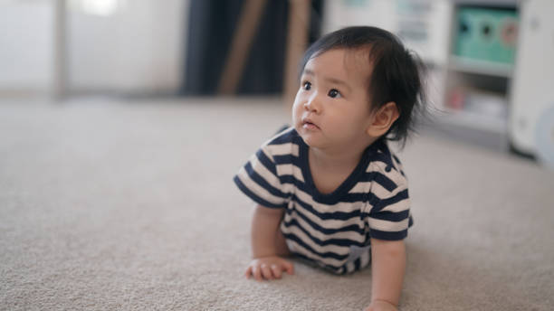 istock Baby girl crawling on floor at home 1998866150