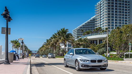 Fort Lauderdale, USA - April 26, 2023: Quiet traffic, on a sunny morning, next to Fort Lauderdale beach, on A1A street, next to modern recently built hotels. Famous beachfront area with a wide variety of water and beach activities, lifeguards and panoramic views.