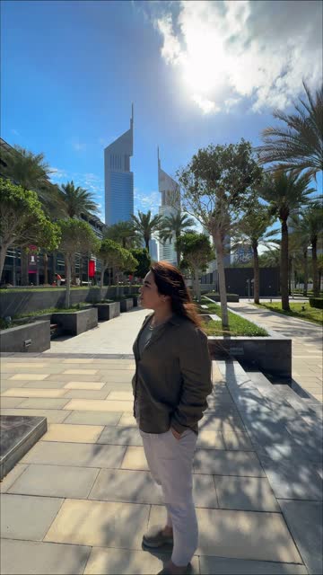 happy girl with long hair spins in the city with a view of high-rise buildings. High quality FullHD footage