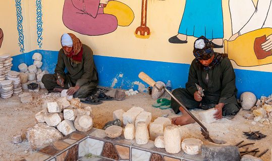 Egypt,  Marsa Alam - March 01, 2019: imitation of the production of alabaster vases near a tourist shop, Egypt