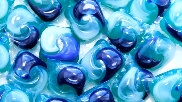 Patterned blue and white laundry capsules on surface