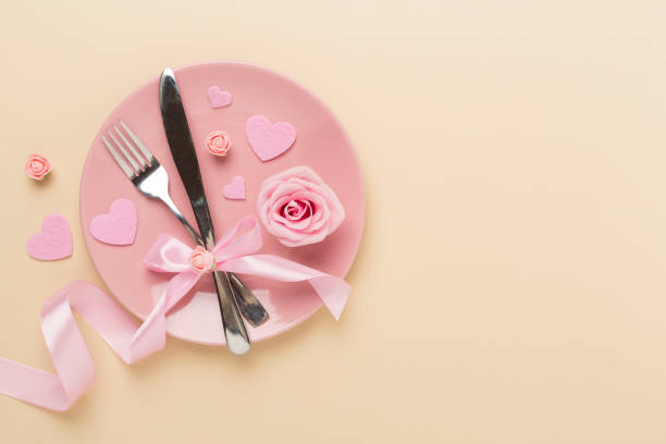 istock Festive table setting for Valentine's Day on color background, top view 1998933130
