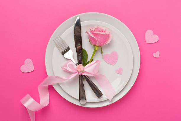 istock Festive table setting for Valentine's Day on color background, top view 1998933134