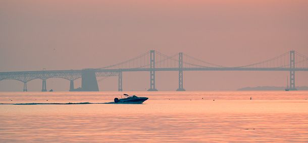 Chesapeake Bay Bridge at sunrise with boat