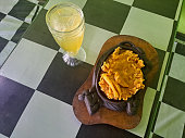 Serving Of Chicken Steak With French Fries On A Hot Plate And Lime Iced Or Es Jeruk Nipis  In Glass. Food And Drink Menu.