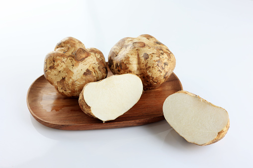 Jicama or Bengkuang on Wooden Plate, White Background