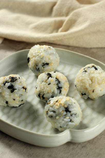 Korean Seaweed Rice Balls or Jumeokbap with Ham, Sausage, Sesame Seed, Sesame Oil, and Vegetable