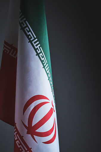 Flag of Iran on a gray background in closeup