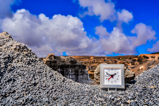 Conceptual Photo Picture of an Alarm Clock Object in the Dry Desert