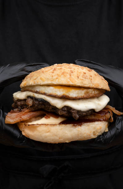 istock Chef presenting delicious gourmet burger 1999058081