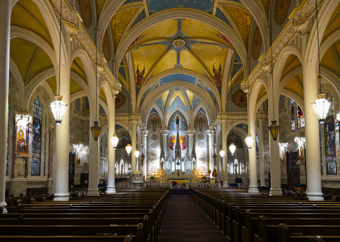 Olean, NY, USA - January 28, 2023: The interior of the Basilica of St. Mary of the Angels, looking down the nave toward the altar. The Gothic Revival church was built in 1915.