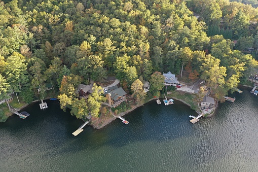 Lake Santeetlah, North Carolina - October 17, 2020 - Aerial view of lake homes on lakeshore on autumn afternoon.