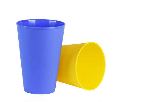 A set of plastic colored glasses. Tableware for a picnic. Isolate on a white background.