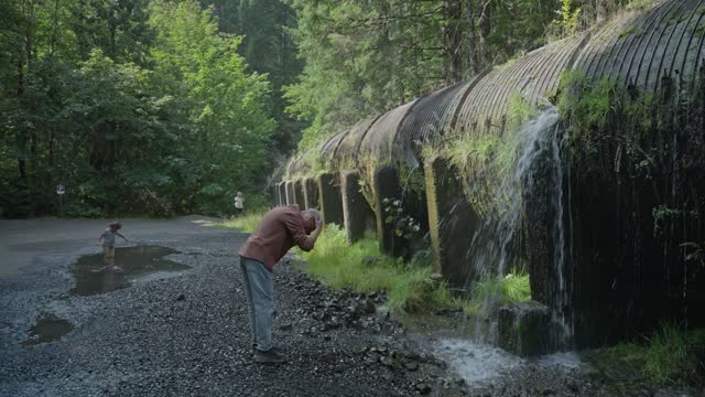 Senior man cooling off in water while exploring nature on a road trip in Oregon