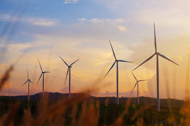 istock Wind turbine generating electricity and sunset 1999353314