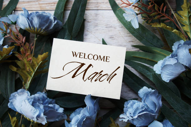 istock Welcome March text message with flower decoration on wooden background 1999385166