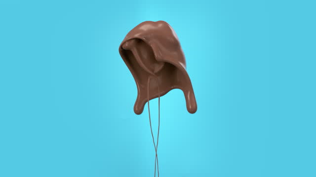 Super slow motion liquid milk chocolate splash cut out on blue screen