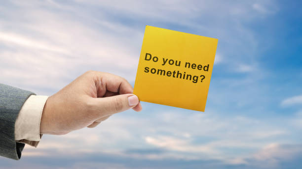 istock Business hand holding a note with 'Do you need something' text 1999409336