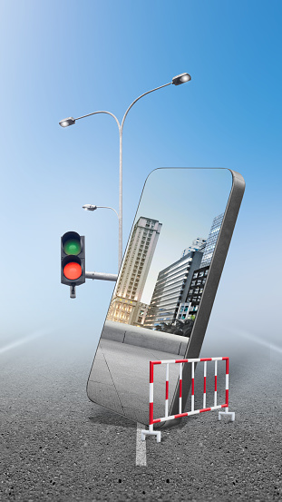 Street with a skyscraper and a city view with blue sky on the mobile phone screen over a colored background. Traveling concept