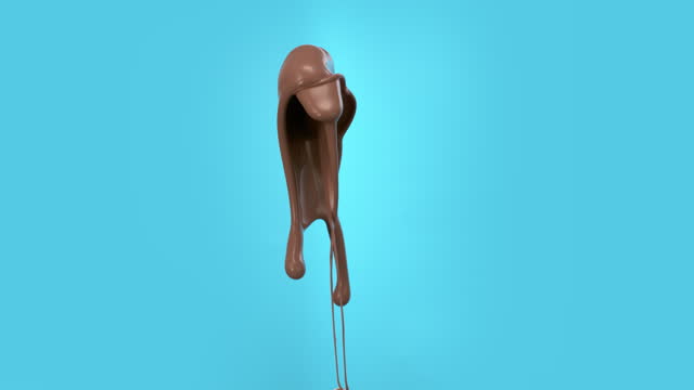 Super slow motion liquid milk chocolate splash cut out on blue