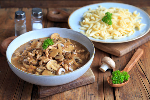 istock Sliced meat with mushrooms and spaetzle 1999517531