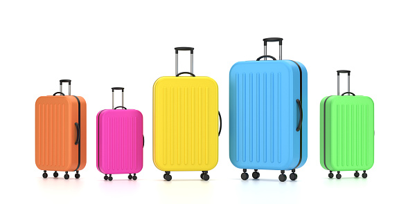 Colorful suitcases at different angles On The White. Travel planning concept.