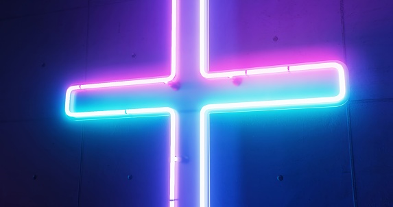 A vibrant and spiritual ambiance is created on the church wall by a shining neon Christian cross.