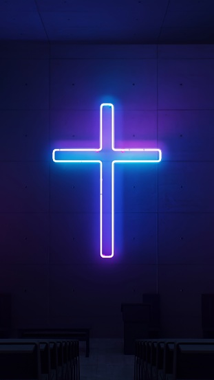 Imbuing the church wall with light, a radiant neon Christian cross exudes a spiritual and vibrant presence.