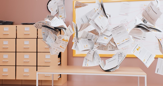 Under the relentless assault of the wind, papers on the office desk are caught in a frenzied dance, forming a miniature tornado.