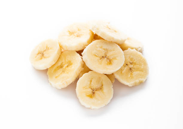 istock Fresh raw organic banana slices on white background. 1999649687