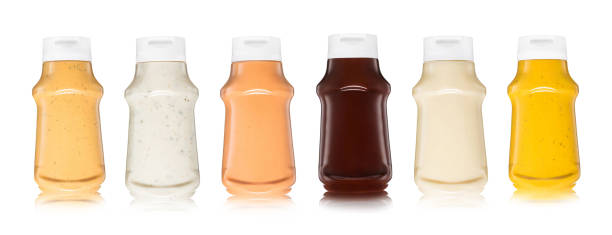 istock Various sauces in plastic bottles on white background.Burger,garlic,mayo,barbecue and mustard sauce 1999650172