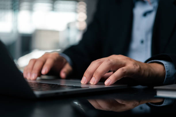 istock Close-up hand professional man typing keyboard on a modern laptop computer work at office, business and technology online efficiency. 1999676257
