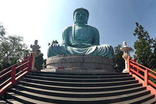 Outdoor great Buddha Daibutsu or Amitabhe Buddha at Wat Pra That Doi Pra Chan. It is a green rust Buddha statue made from a mixture of copper that was used to create it.