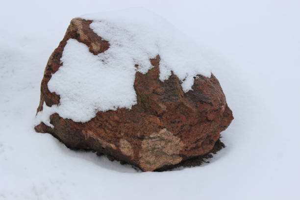 istock Huge granite stone in the winter garden. 1999685542