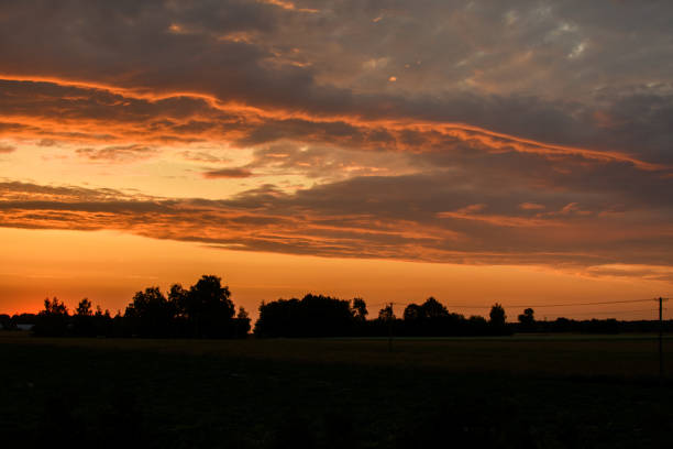 Intense colors of the setting sun in a cloudy sky