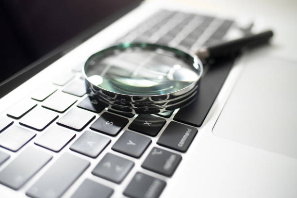 istock Laptop computer with magnifying glass as a symbol for searching information on the internet 1999742626