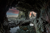 Sunrise from inside the cave of Campiecho in Asturias, Spain