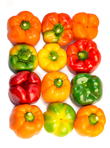 Raw colorful bulgarian pepper on white background. a few peppers neatly laid out