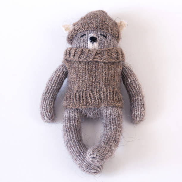 istock Knitted woolen bear in a sweater and hat 1999765627
