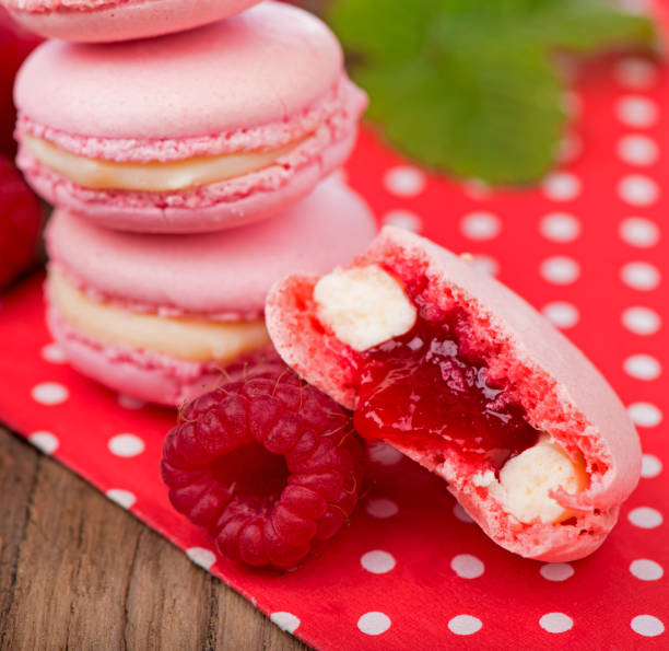 istock French makarons cake . Pink raspberry macaron cookies on dark wooden boards 1999767695