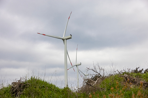 windmill powered plant on hilltop