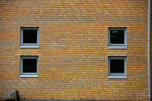 Four small windows in a brick wall.