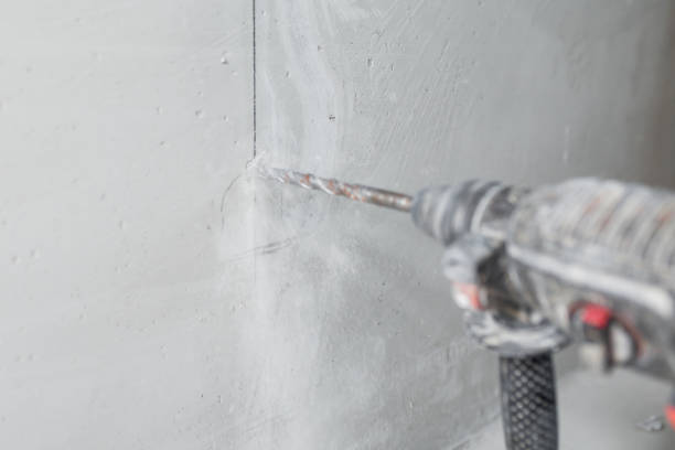 istock Powerful electric hammer drill for drilling and scoring a concrete wall 1999799856
