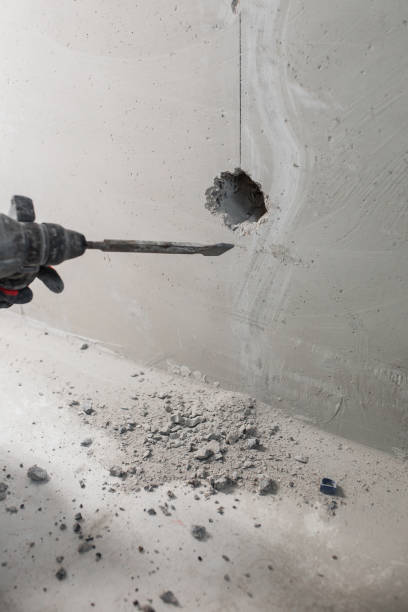 istock Powerful electric hammer drill for drilling and scoring a concrete wall 1999800376