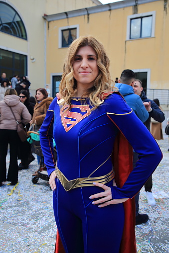 Pagani, Salerno, Italy-February 04,2024: A young actress poses for a souvenir photo with the costume of Supergirl during a party for the children of the city.