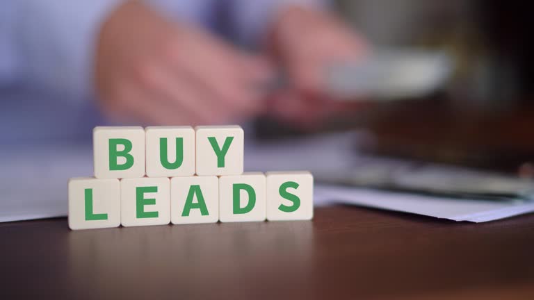 Concept of buying leads as a marketing strategy. Selective focus with money on the background.