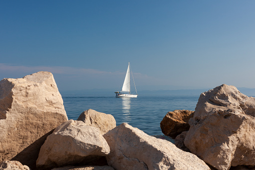 Sailing boat on Adriatic Sea, seen from Piran coast in the summer season, Slovenia