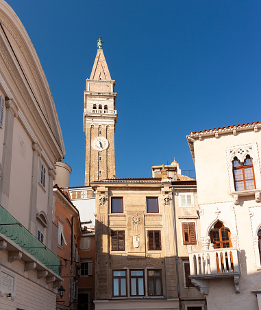 Historic buildings in Tartini Square in the medieval centre of Piran on the coast of Slovenia. The belltower of St George's Parish Church is in the background