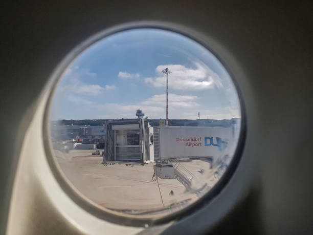 Dusseldorf, Germany - march 24, 2017 - the view of Dusseldorf international airport ramp at day and airport jetway view from airplane window is appear